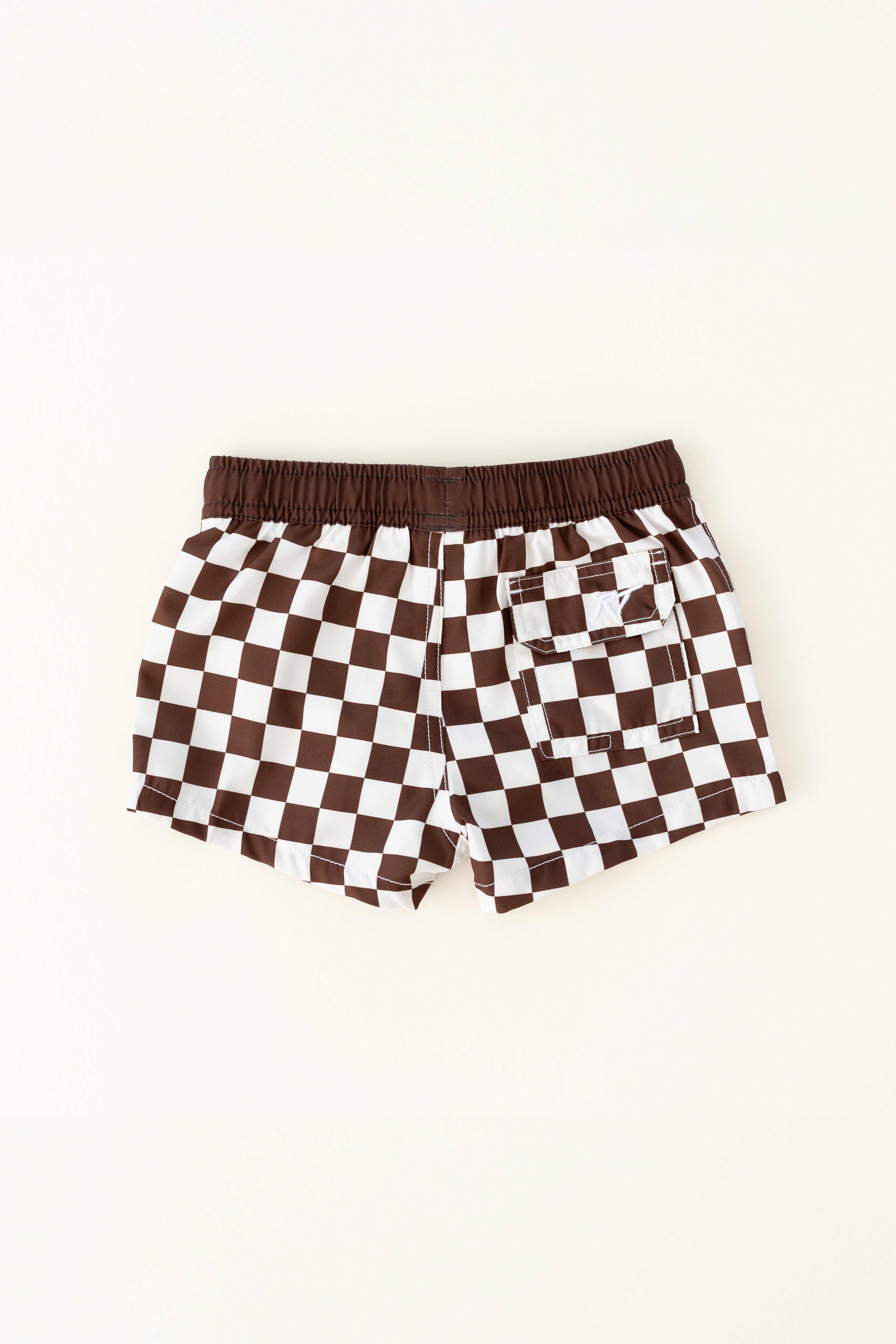 backside of Trendy checkered swim shorts with an elastic waistband and drawstring, made from quick-drying fabric. Ideal for swimming, beach trips, and outdoor activities. Features vibrant patterns and a comfortable fit for active kids.