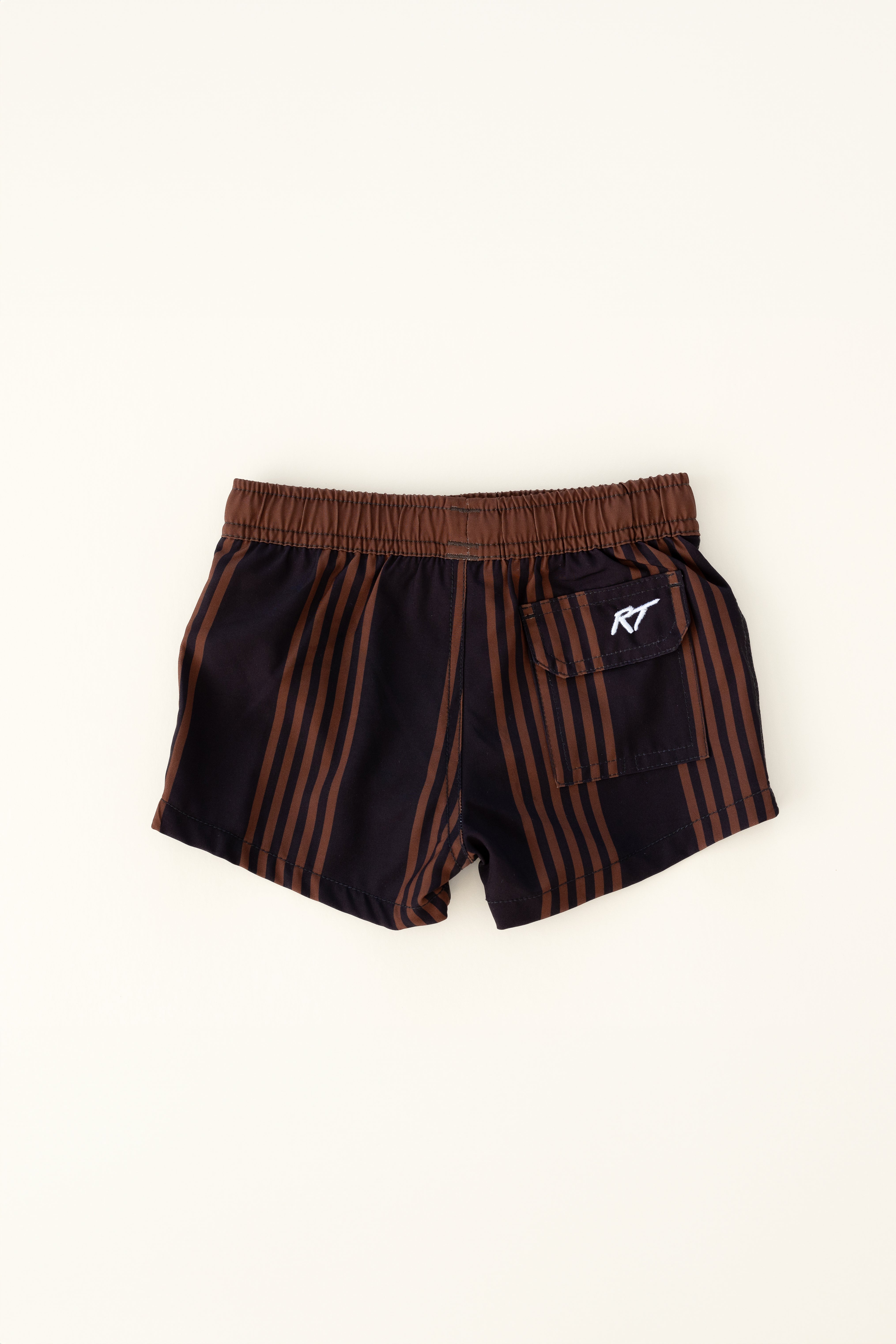 backside of espresso colored Trendy swim shorts with an elastic waistband and drawstring, made from quick-drying fabric. Ideal for swimming, beach trips, and outdoor activities. Features vibrant patterns and a comfortable fit for active kids.